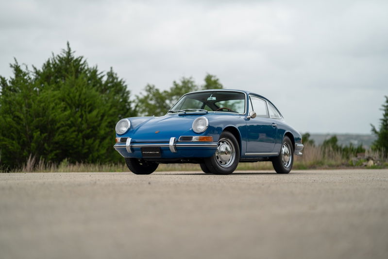 1965 Porsche 912 coupe in blue, featuring chrome rims and trim.