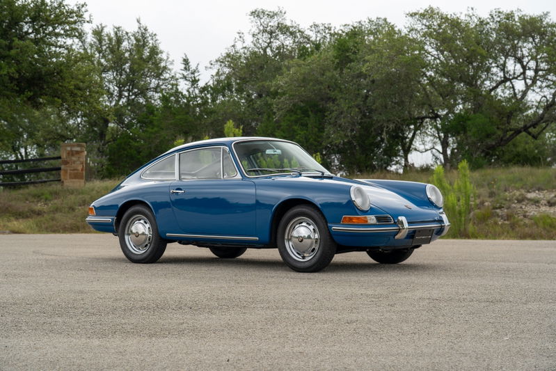 A blue 1965 Porsche 912 Coupe with chrome trim and Fuchs wheels.