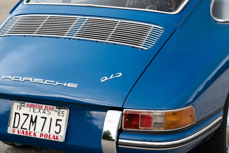 Blue 1965 Porsche 912 with chrome trim and a Texas license plate.