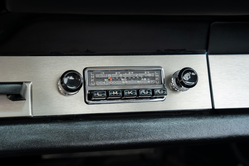 Vintage Porsche 912 dashboard with brushed metal trim and classic radio.