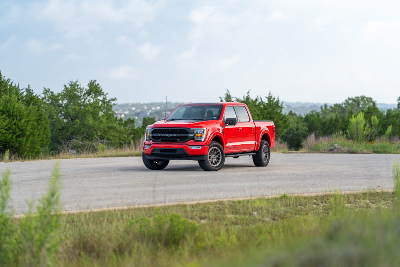 Red 2022 Ford F-150 Roush with aggressive front trim and dark rims.