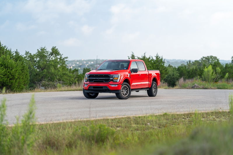 Red 2022 Ford F-150 Roush with aggressive front trim and dark rims.