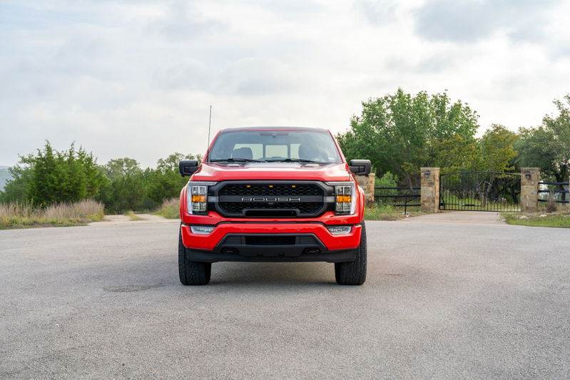 Front view of a red 2022 Ford F-150 Roush with black grille trim.