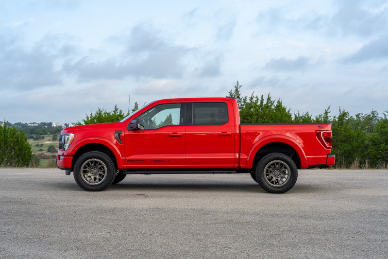 Red 2022 Ford F-150 Roush with dark grey rims parked on asphalt.