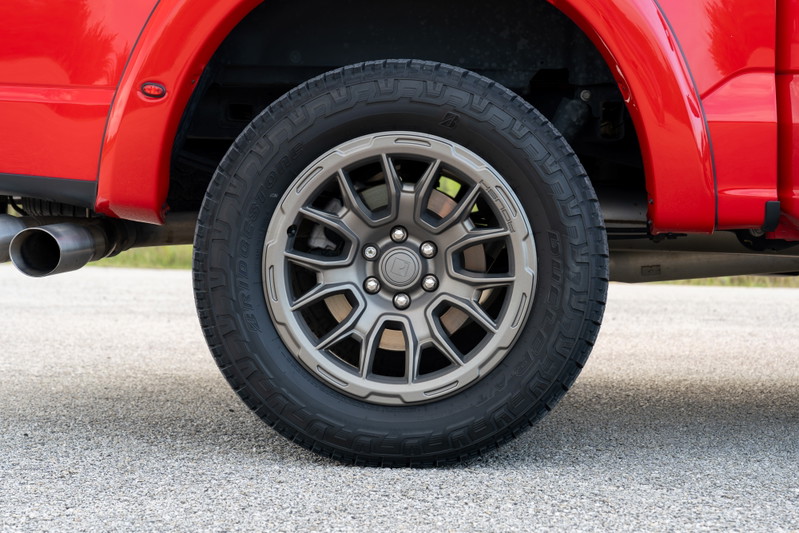 Red 2022 Ford F-150 Roush with gray multi-spoke rims and all-terrain tires.