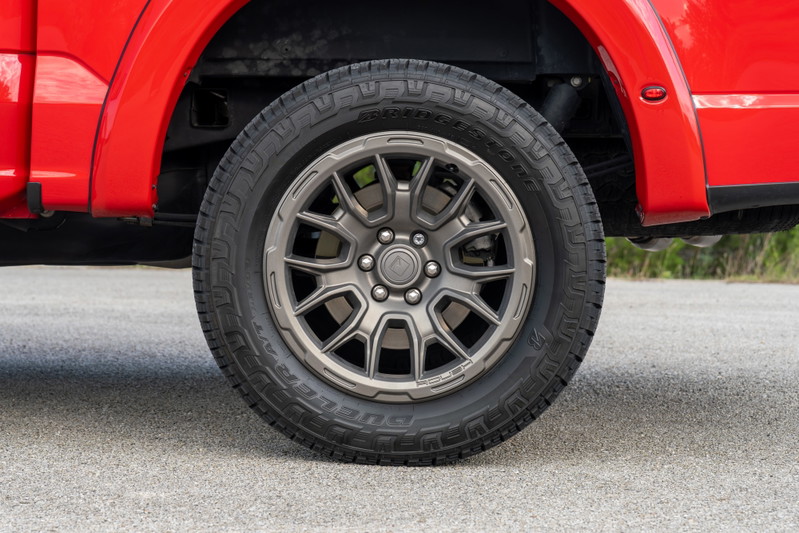 Red 2022 Ford F-150 Roush with aftermarket gray alloy rims and all-terrain tires.