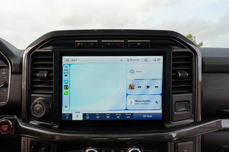 2022 Ford F-150 Roush in red with touchscreen infotainment system and digital cluster.