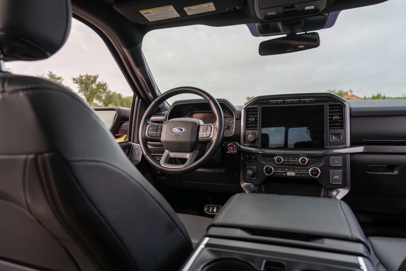 2022 Red Ford F-150 Roush interior with black leather seats and large touchscreen.