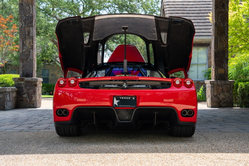 Rear view of a Rosso Corsa 2003 Ferrari Enzo with doors open.