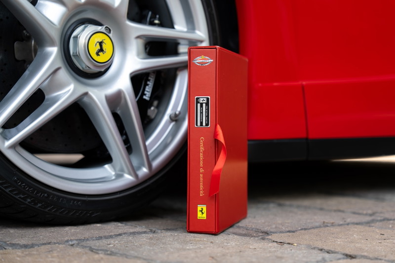 Rosso Corsa Ferrari Enzo detail: silver alloy wheel, caliper, and red binder.