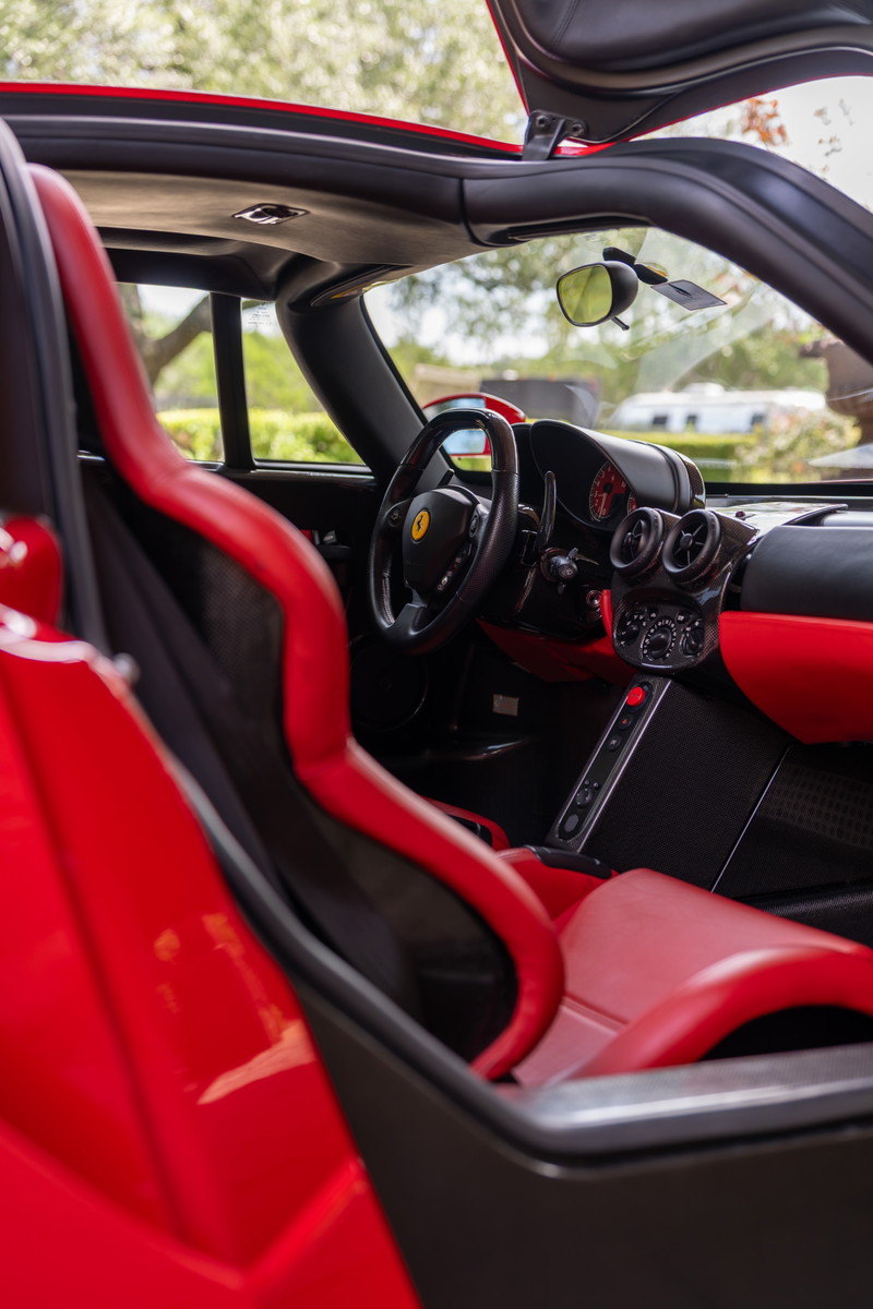 Rosso Corsa 2003 Ferrari Enzo interior, with red leather racing seats and carbon fiber trim.