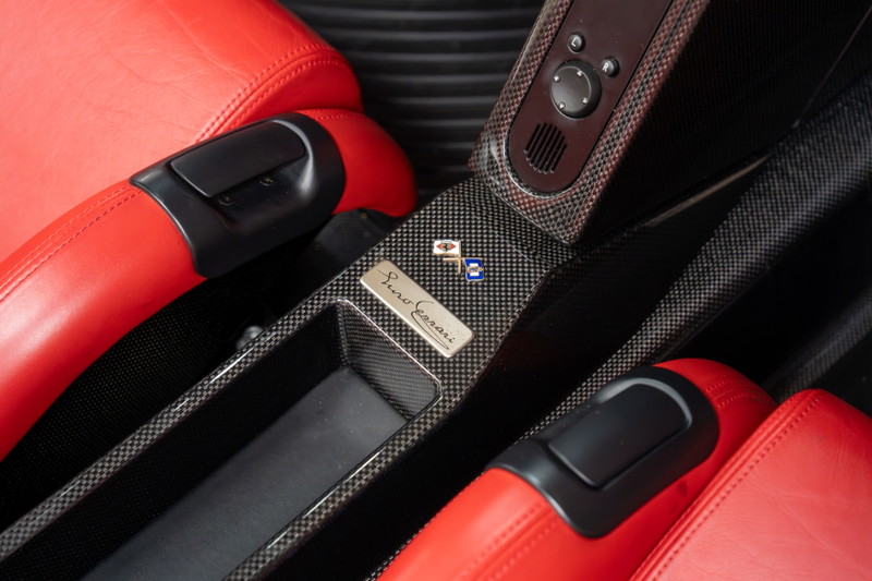 Rosso Corsa Ferrari Enzo interior with carbon fiber trim and red leather seats.