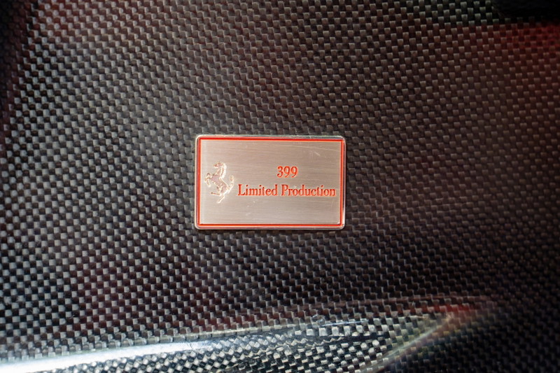 Ferrari Enzo limited production badge on carbon fiber trim.