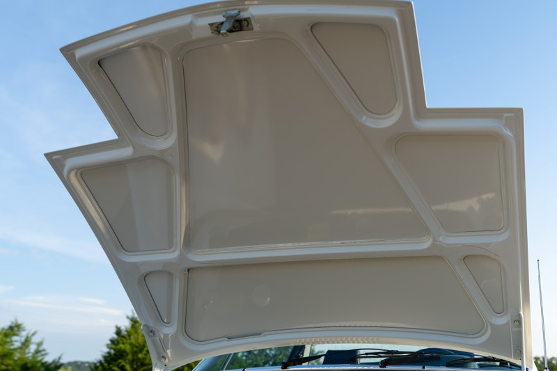 The underside of the white hood of a 1974 Porsche 914 Can-Am LE.