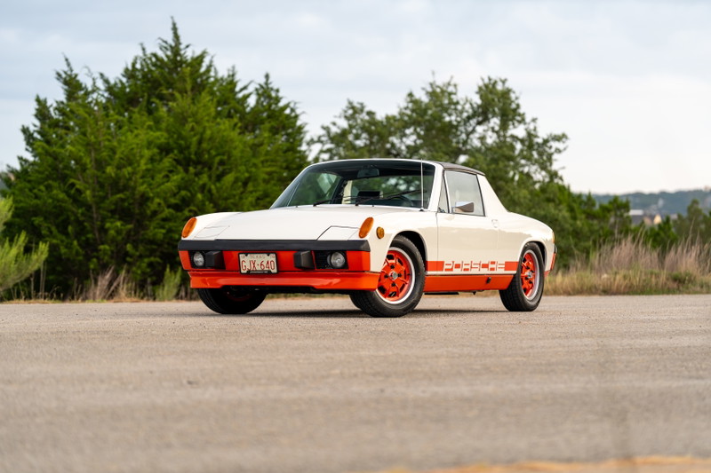 1974 Porsche 914 Can-Am LE in white with orange trim and "PORSCHE" livery, on orange rims.