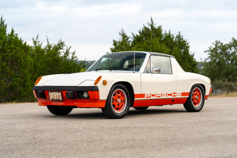 White 1974 Porsche 914 with orange trim, Porsche livery, and orange rims.