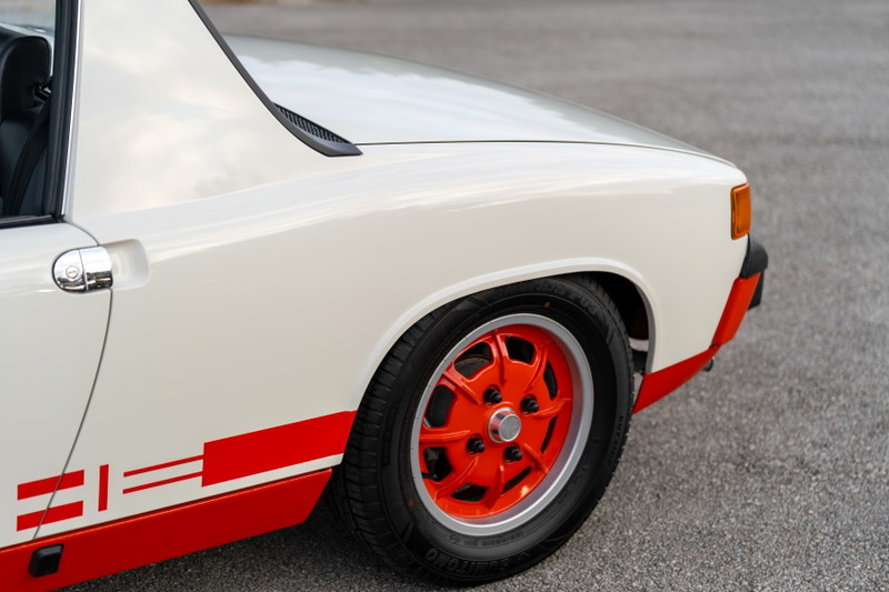 1974 Porsche 914 Can-Am in cream white with red livery and orange racing rims.