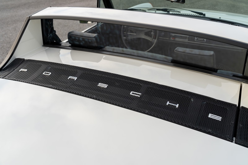 White 1974 Porsche 914 Can-Am with black mesh trim and "PORSCHE" lettering.