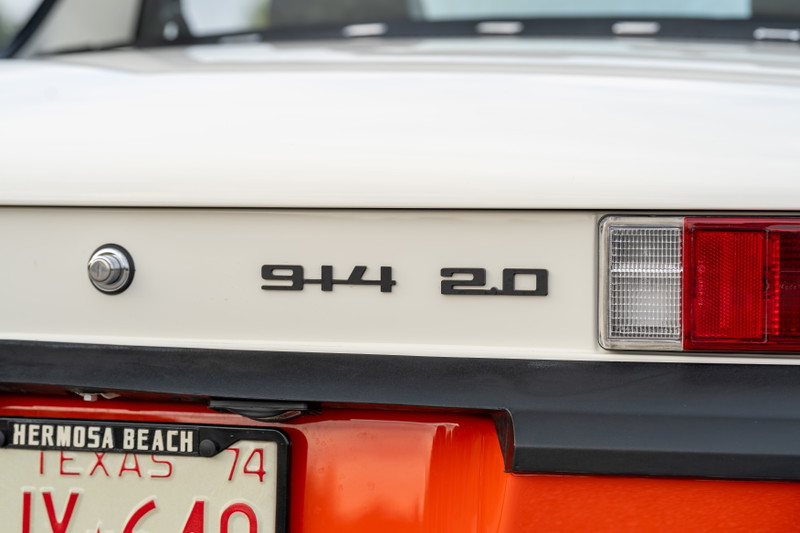 1974 Porsche 914 2.0 badge on a white rear panel with black trim.
