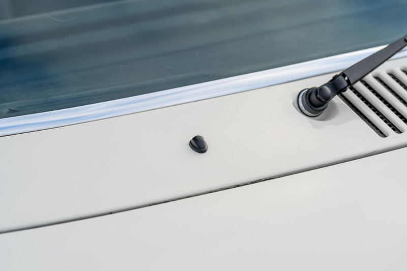 Detail of a cream 1974 Porsche 914 Can-Am with wiper assembly and dash vent.