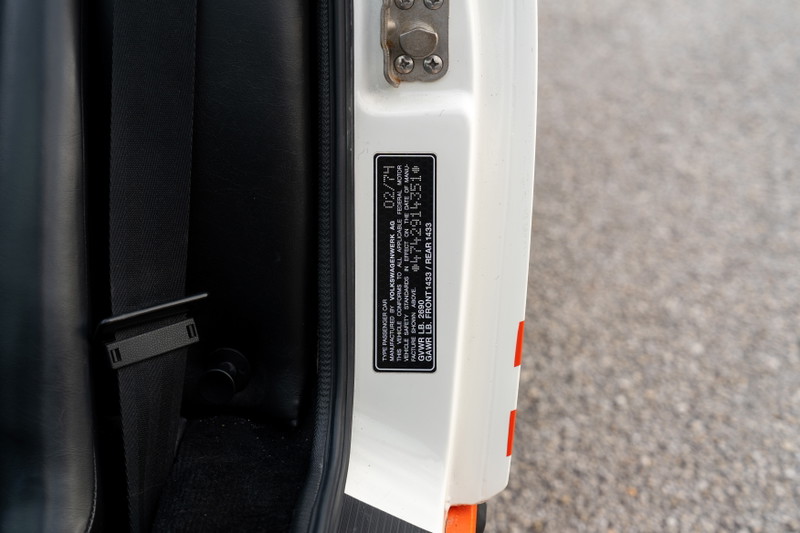Close-up of a 1974 Porsche 914 Can-Am LE door jamb sticker with VIN and weight info.