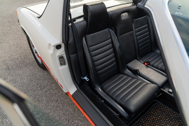 1974 Porsche 914 Can-Am LE interior with black ribbed seats and orange trim.